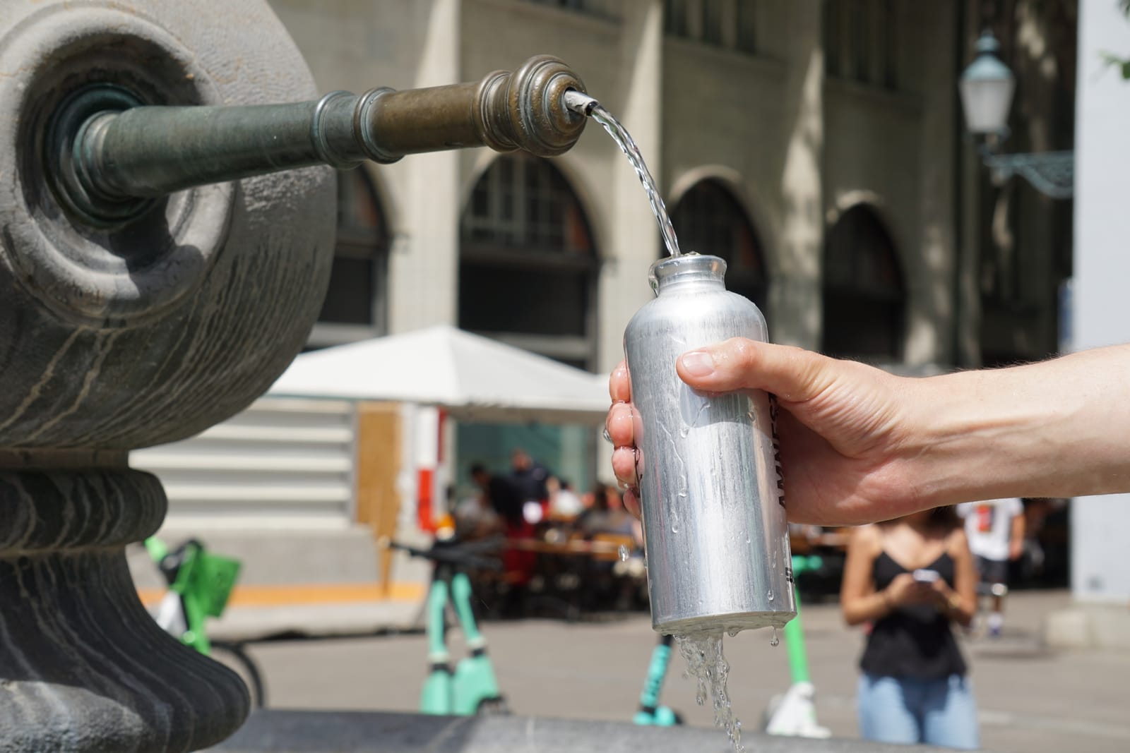 Filling a metal bottle during an outdoor activity